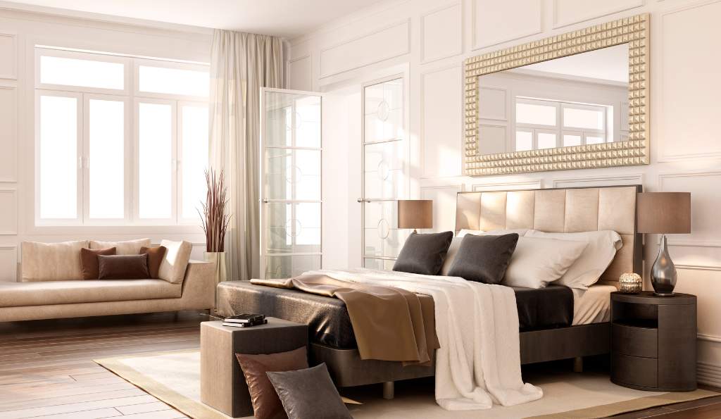 Luxurious modern bedroom with a stylish upholstered bed, elegant decor, warm lighting, and a cozy seating area near large windows with natural light furniture