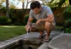 How to Tell If Your Blocked Drain Is a Quick Fix or a $10,000 Problem Homeowner checking an underground utility pit for a possible hidden water leak