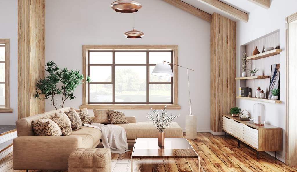 Cozy living room with a beige sectional sofa, wooden flooring, large window, modern lighting, indoor plants, open wooden shelves, and a minimalist coffee table in a neutral-toned decor furnite