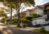 Why Tradie Callouts Cost More in Some Sydney Suburbs Than Others Plumbing service van parked outside residential homes on a suburban street