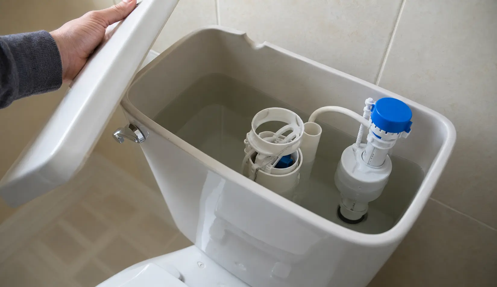 Inside a toilet cistern showing the fill valve, a common hidden cause of water waste